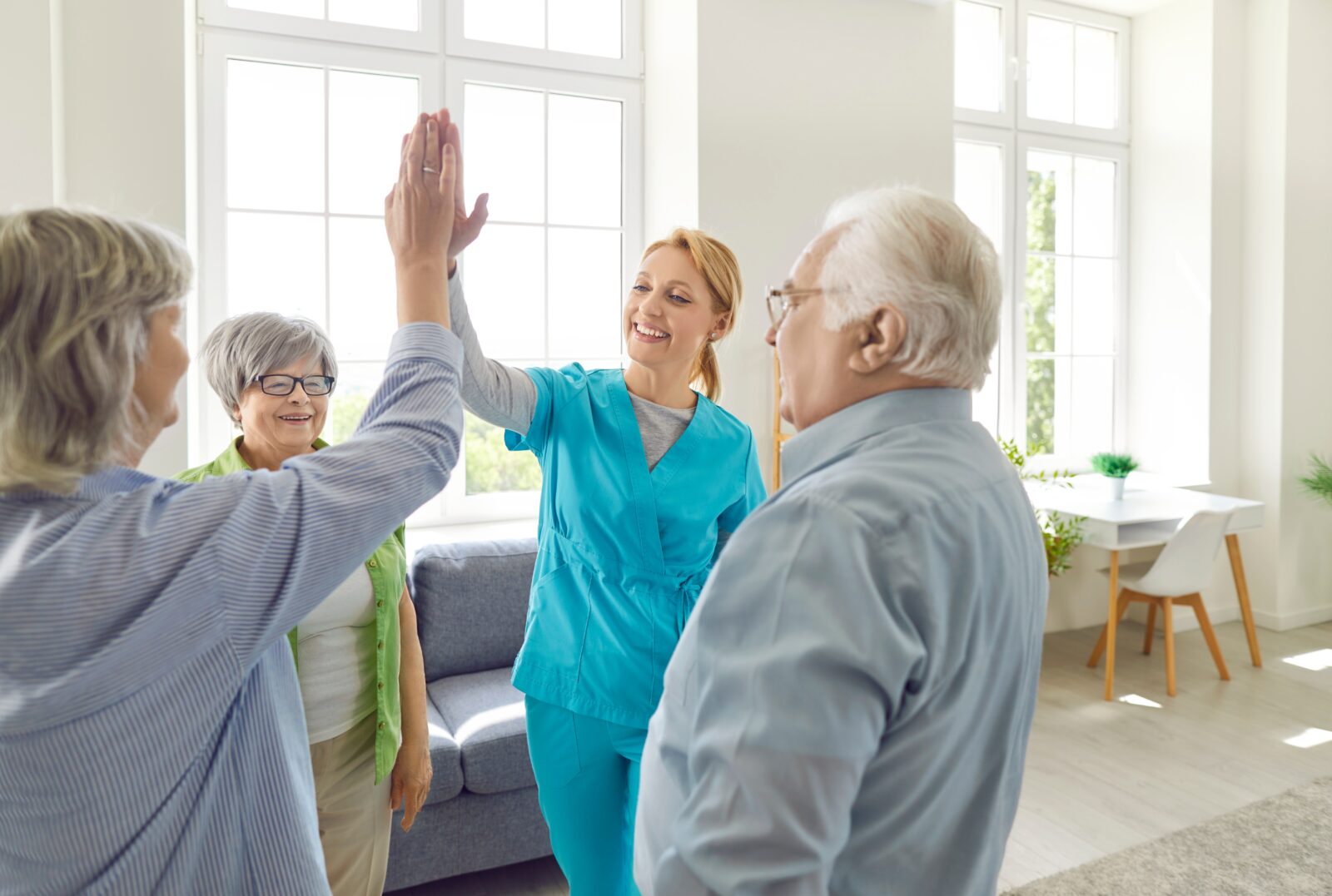 Senior people retirement home activity, high five with skilled nurse, nursing care and service, happy old people enjoy good time, elder patients under supervising and gerontological guiding, playing